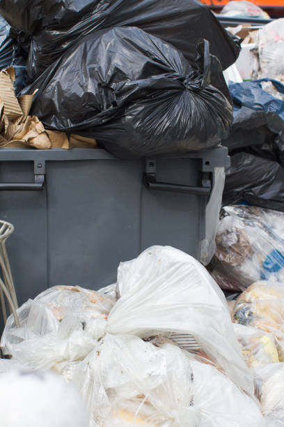 istock plastic garbage bags loaded with food and junk overflowing container 1474783155