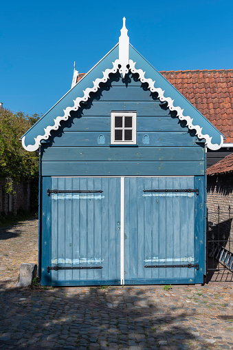 Typical wooden facade of a garage in the Wijngaardstraat in Veere. Veere is a city in the province of Zeeland in the Netherlands