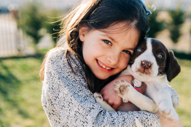istock Smiling Little Girl Posing With Her Puppy 1474785202