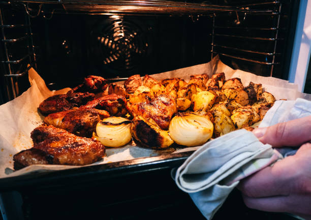 istock Potato and chicken with spices is baking in electric oven. 1474786787