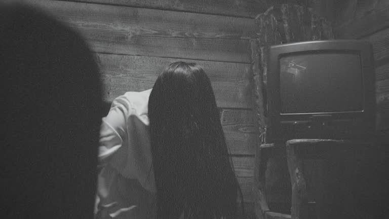 Scary Ghost Woman Crawling or Walking In Horror Halloween Scene . Droning television inside dark empty room . Little girl in white sundress . Girl with long black hair.