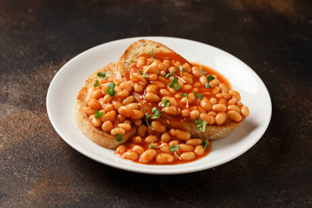 istock Baked beans on toast in tomato sauce on white plate 1474787480