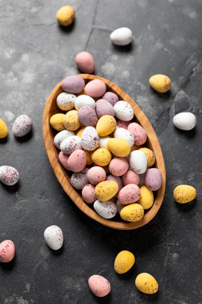 istock Easter mini eggs, chocolate candy in wooden bowl 1474787867