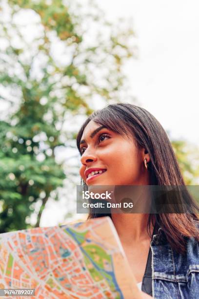 Closeup Of A Traveler Woman Looking At A Map On A Vacation Adventure Stock Photo - Download Image Now