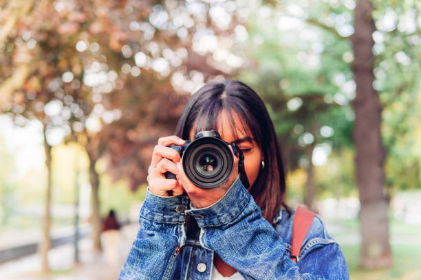 istock Casual woman taking photo on camera 1474789245