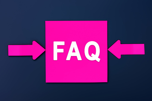 FAQ (Frequently Asked Questions) - inscription of a magenta paper notes and two colorful arrows over a dark blue background. Top view. Instructions and rules on Internet sites