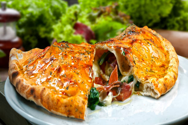 deliciosa pizza calzone, comida italiana - pizza pastry crust oven meat - fotografias e filmes do acervo