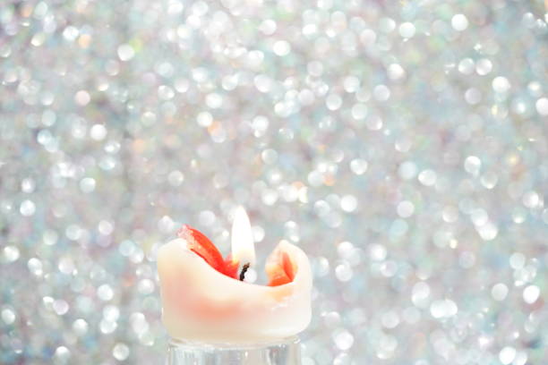 white candle with red wax and yellow flame