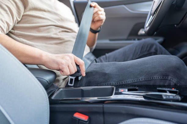 putting on safety seatbelt - fastening imagens e fotografias de stock