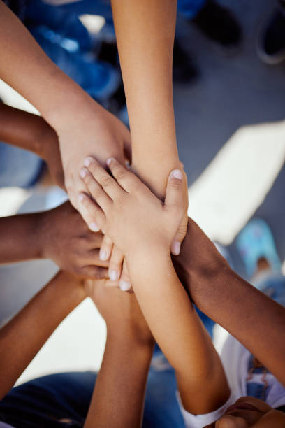 istock Hands, together and support, children solidarity and trust, commitment and team motivation top view. Diversity, teamwork and youth group with development, growth and kids community with connection 1474797535