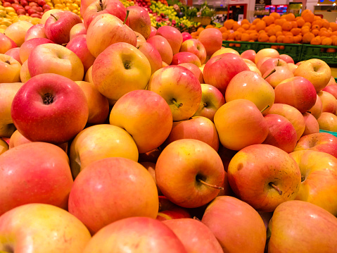 Background from a group of red apples on a counter at the market