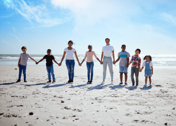 praia, de mãos dadas e mulheres lésbicas com filhos para apoio, diversidade de férias e grande amor familiar na indonésia. confiança, esperança e retrato de pais com filhos para uma viagem de férias no mar - trust human hand sea of hands holding - fotografias e filmes do acervo