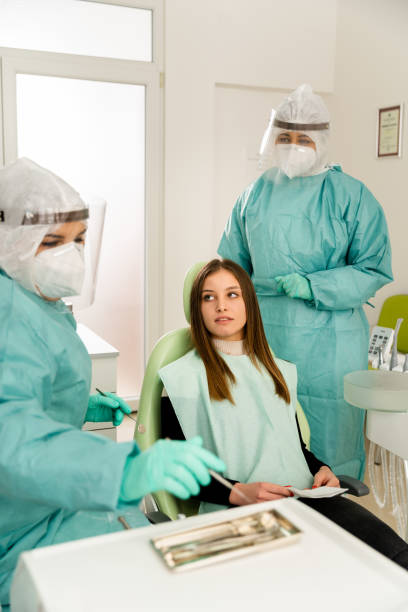 istock Dentist And Assistant Working On A Patient In Dentist Clinic 1474799349