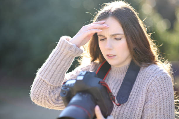 istock Worried photographer checking photos on camera 1474799423