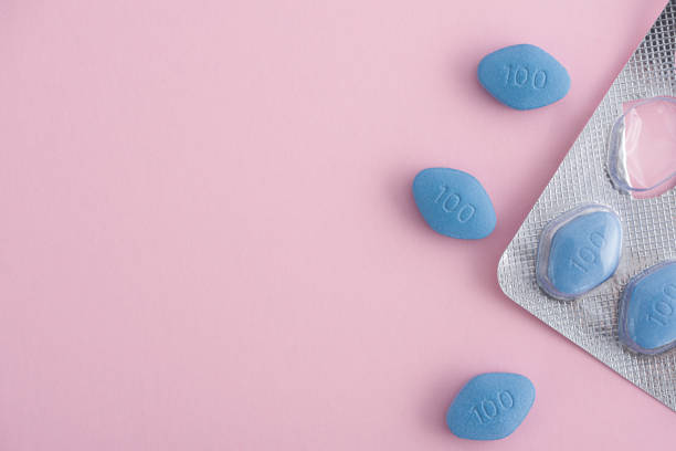 Blue pills viagra pack with tablets on pink background. Medicine concept of medication for treatment of erectile dysfunction Blue pills viagra pack with tablets on pink background. Medicine concept of medication for potency, erection, treatment of erectile dysfunction. Top view with copy space erection stock pictures, royalty-free photos & images