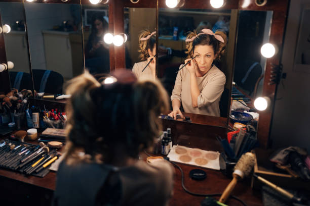 istock Theater actress looks in the mirror while doing her make-up 1474800309