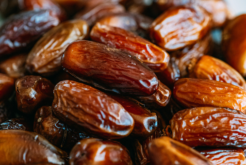 Dried mixture of walnuts and dried fruits, raisins, grapes and prunes close-up. Mix for adding to baked goods or appetizers. Healthy vegan food.