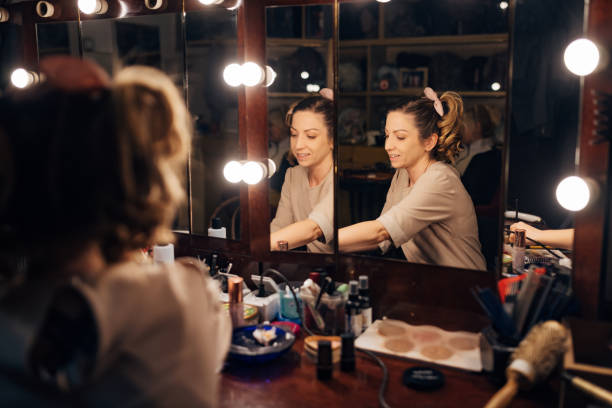 istock While sitting in front of the mirror in the theater backstage, the actress fixes her make-up 1474800385