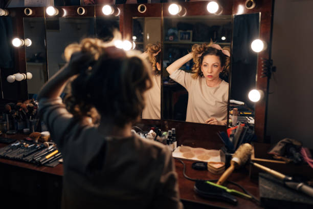istock A theater actress is preparing for a performance, fixing her hair and make-up 1474800409