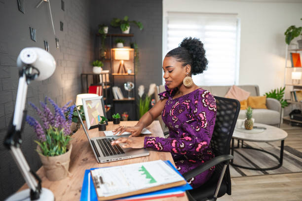 istock Happy black woman working on a laptop 1474800898