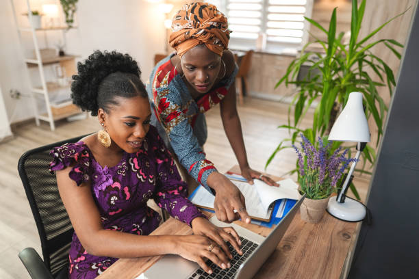istock Two black female colleagues working together on laptop 1474801042