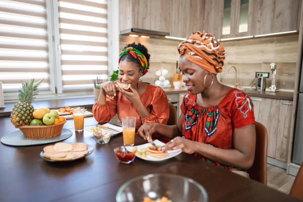 istock Female friends enjoying their breakfast in the kitchen 1474801327