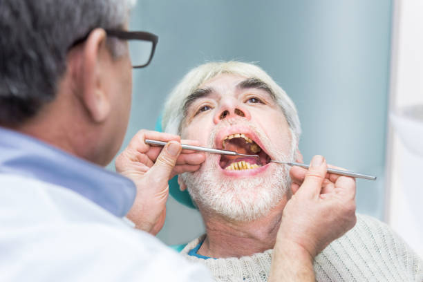 istock Old man at dentist office. 1474803243