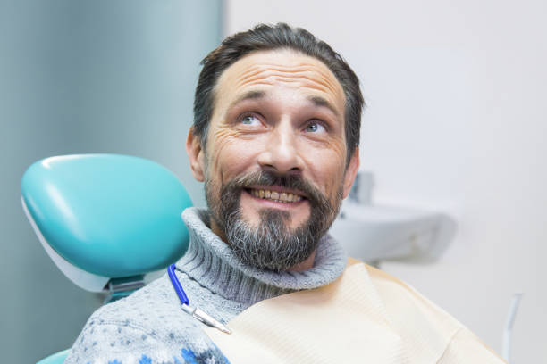 istock Man in dental chair smiling. 1474804311