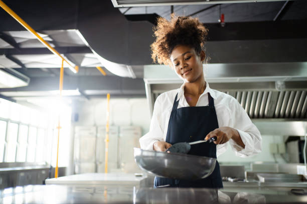 istock Female chef cooking in kitchen. 1474806826