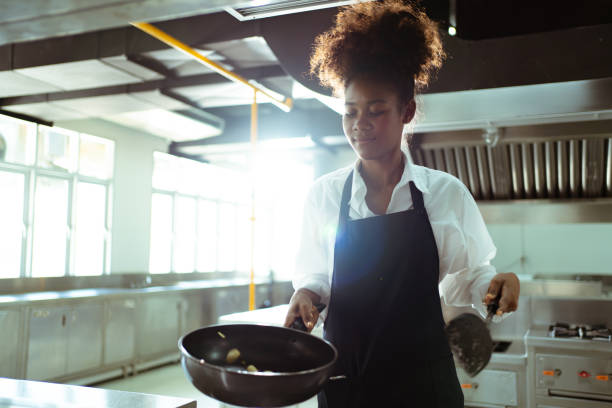 istock Female chef cooking in kitchen. 1474806903
