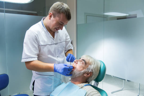 istock Dental doctor with senior patient. 1474807026