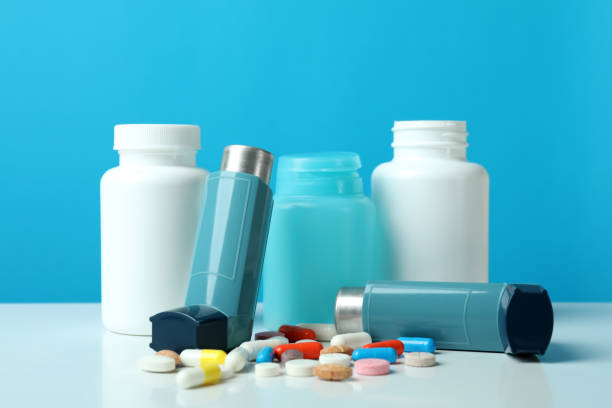 istock Asthma treatment accessories against blue background, close up 1474808536