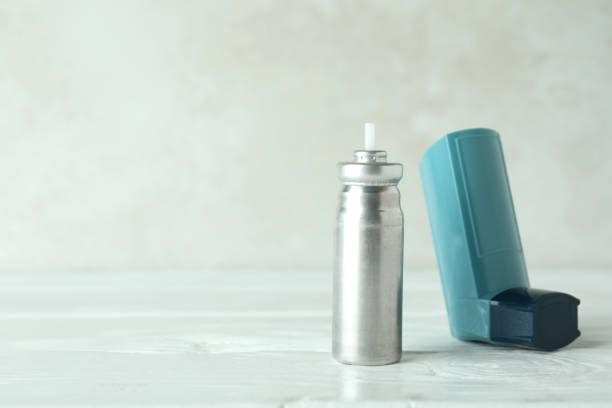 istock Blue asthma inhaler on white wooden table 1474809204