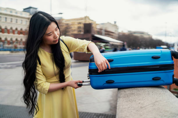 A girl tourist checking her suitcase stock photo