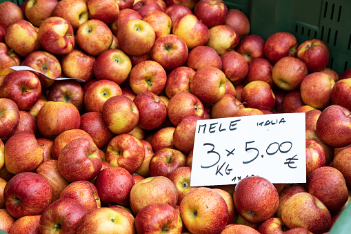 Apples price sign on a white board at a street market; Piove di Sacco, Veneto, Italy