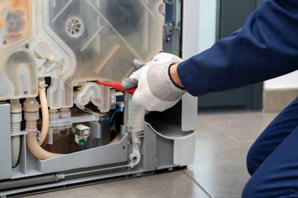 istock repairman using a screwdriver fixing the dishwasher 1474811542