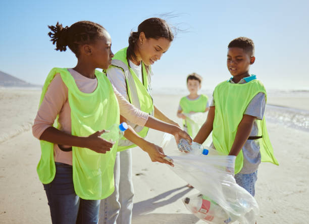 istock Children, beach and plastic recycling teamwork for pollution ecology and environmental change collaboration. Eco friendly team, diversity and ocean garbage recycle together for community cleaning 1474811908