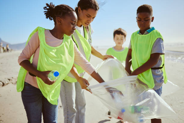 istock Diversity, beach cleaning and plastic recycling for teamwork, pollution ecology and environmental change collaboration. Eco friendly team, interracial people and ocean garbage recycle together 1474811915