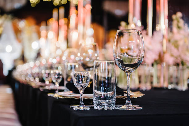 istock Plate and glass, stack, wine glass, luxury golden rich decor. Wedding set up, dinner table reception. Serving, setting table. Side view. Closeup. Birthday, baptism, event. Closeup details interior. 1474811953