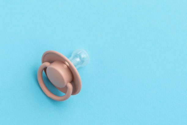 istock Pink baby pacifier on blue background with copy space, top view, flat lay. Newborn concept 1474814995