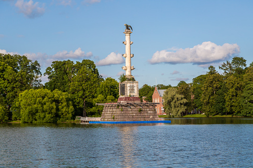 Pushkin, Russia - July 12, 2022: Chesme Column on the island of Grand Pond in Catherine park in Tsarskoye Selo. High quality photo