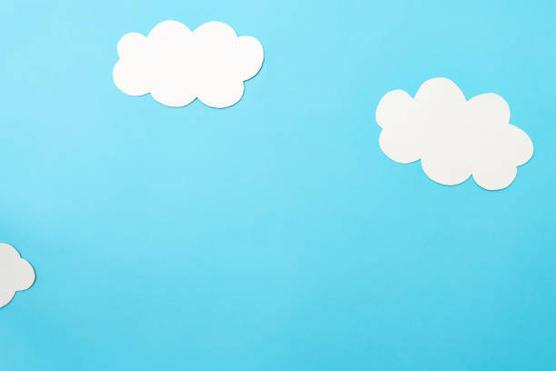 istock White paper clouds and sky concept on a blue paper, flat lay, top view 1474817268