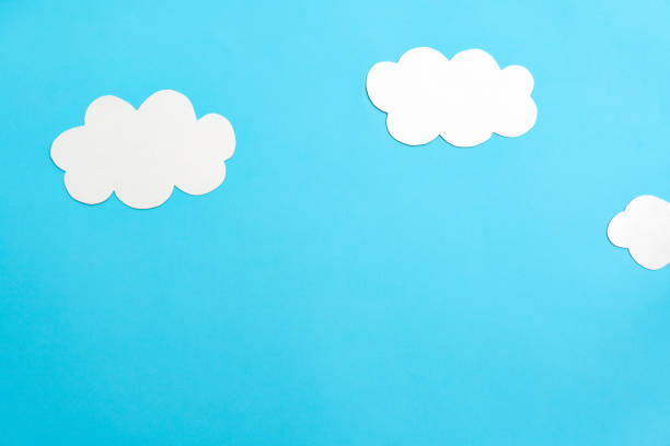 istock White paper clouds and sky concept on a blue paper, flat lay, top view 1474817293