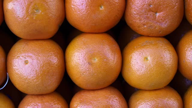 Grapefruits on the market. Juicy ripe citrus fruits on the counter in summer