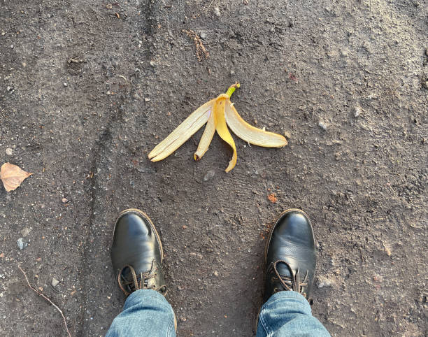 Man standing next to a slippery banana peel.
