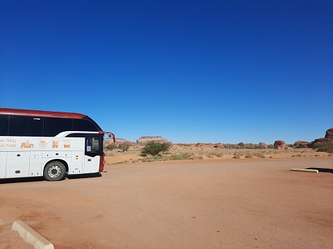 Buses are parked at different places in the desert to take tourists to different places during the day in Al-Ula, Saudi Arabia.