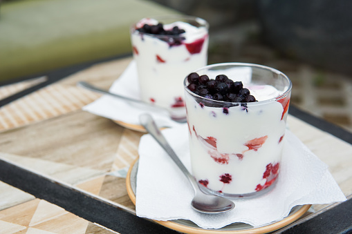 Sweet yogurt dessert with fresh fruits in a glass