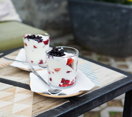 Sweet yogurt dessert with fresh fruits in a glass