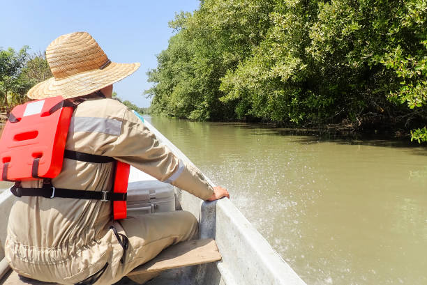 istock A biologist traveling on a boat on the river 1474828778