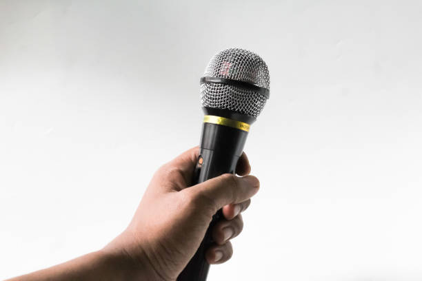 istock the hand holding the microphone 1474829395